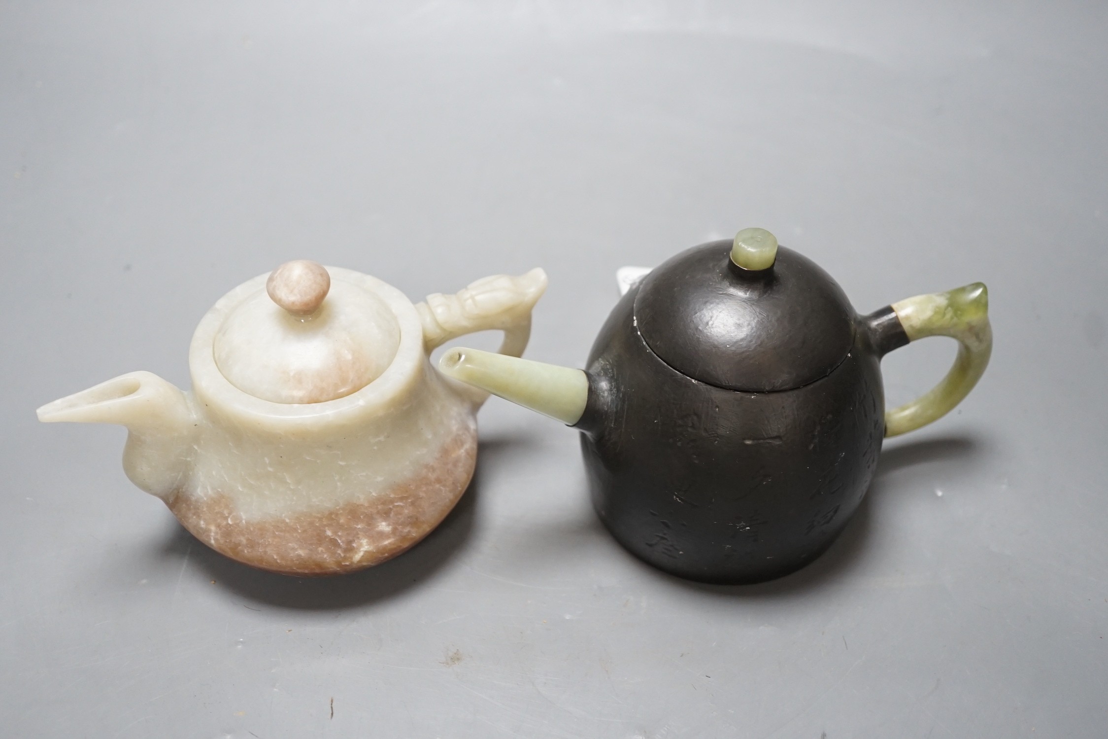 A Chinese jade wine pot and a Yixing pewter and bowenite jade mounted tea pot (2)